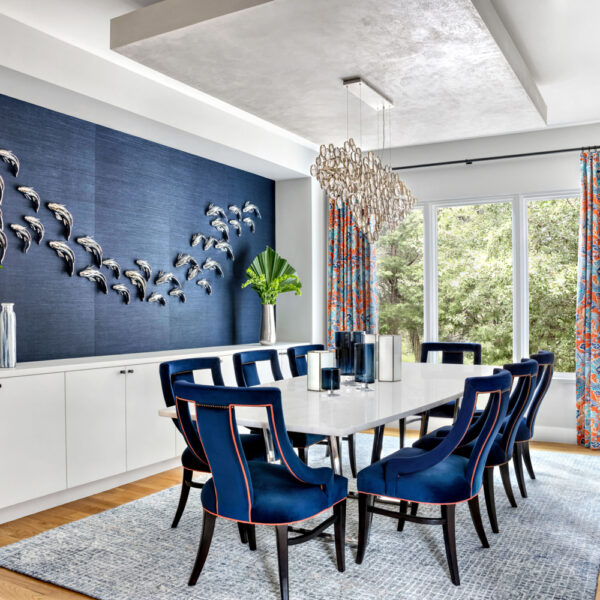 Etch Design Group dining room with blue chairs and blue wall