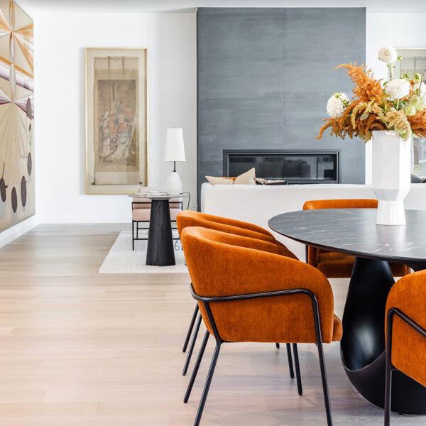 Layers + Lines great room with wood floors and bright orange seating