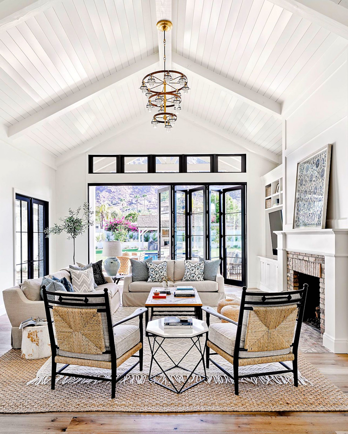 White living room with vaulted ceilings and sliding doors. RED Winner
