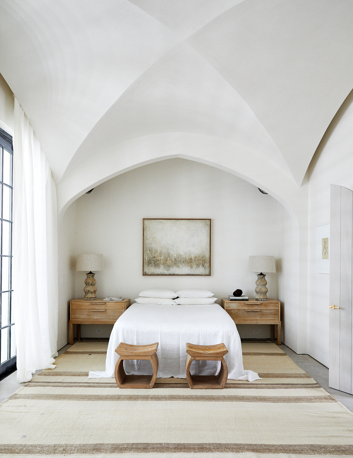 Crisp white bed in a white room with vaulted ceilings. RED Winner