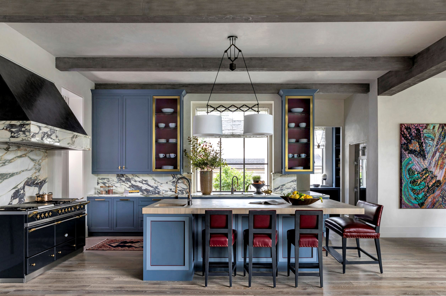 Red and black upholstered barstools line a denim-colored island with butcherblock slab. RED Winner.