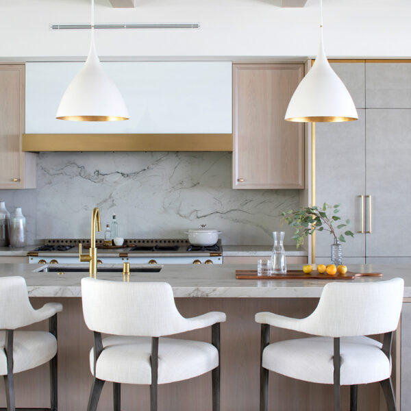 White and cool-toned greys are adorned with brass fixtures that mimic the white and gold light fixtures. RED Winner.