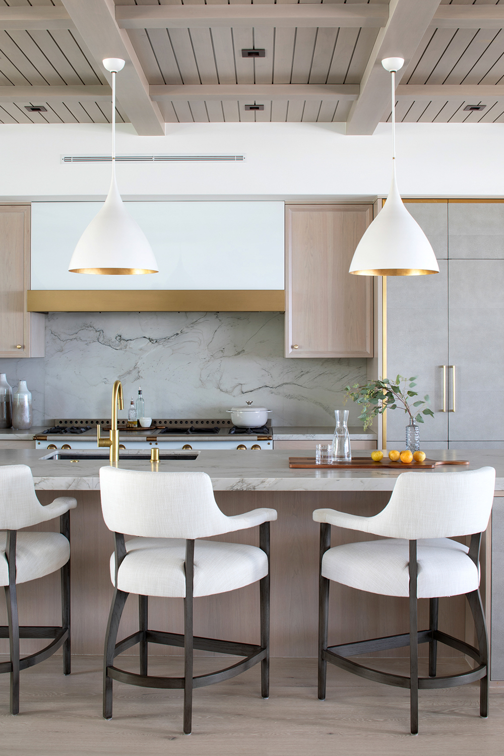 White and cool-toned greys are adorned with brass fixtures that mimic the white and gold light fixtures. RED Winner.