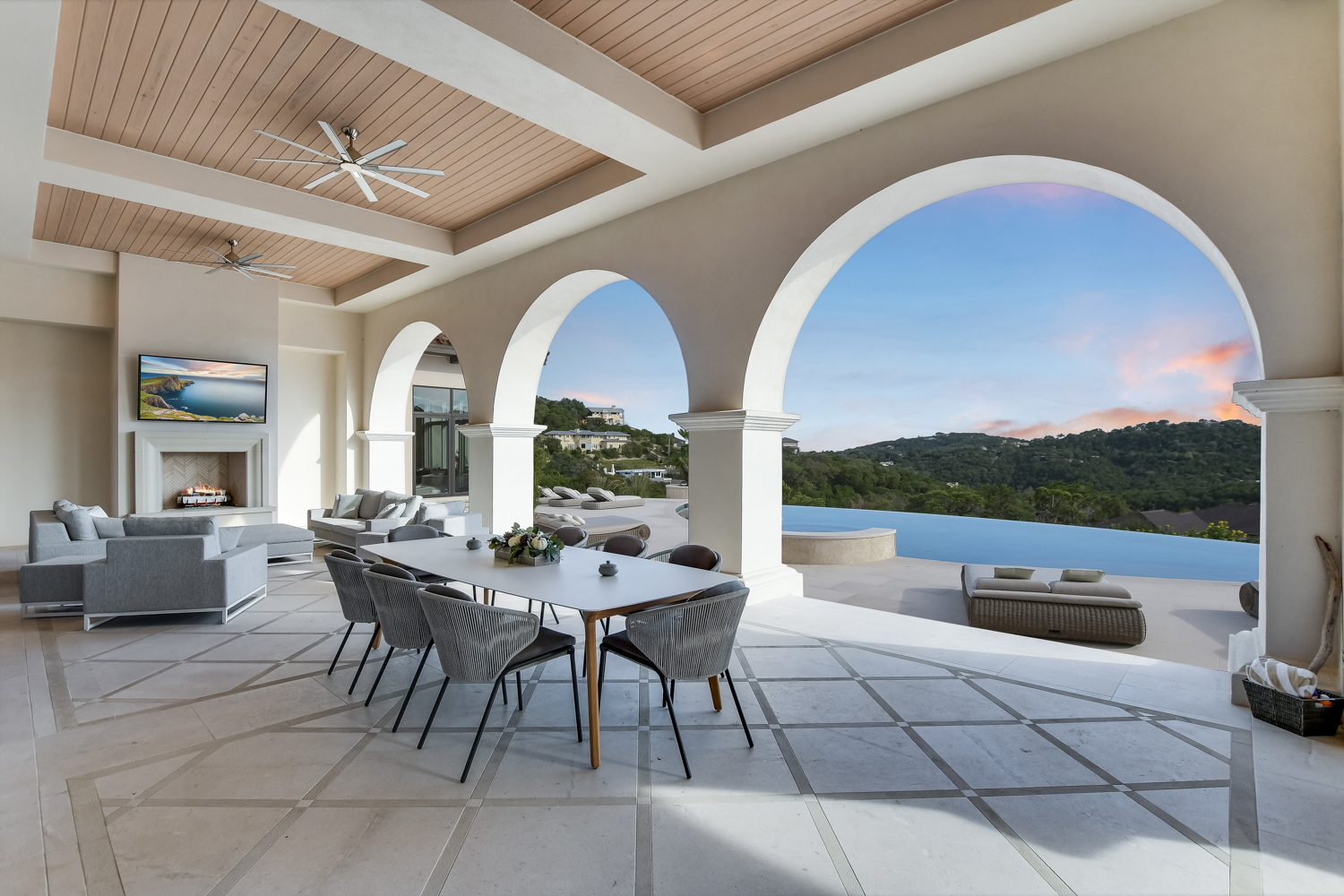 Jauregui Architect patio with arches and pool at sun set