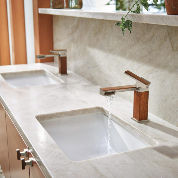 Two wood clad rectangular faucets over rectangular inset sinks on a quartz countertop. RED Winner.