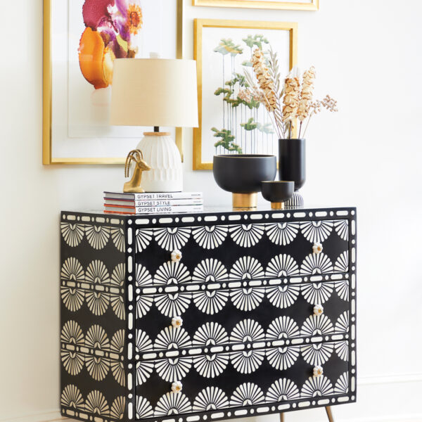 A black and white printed chest with art overhead. RED Winner.