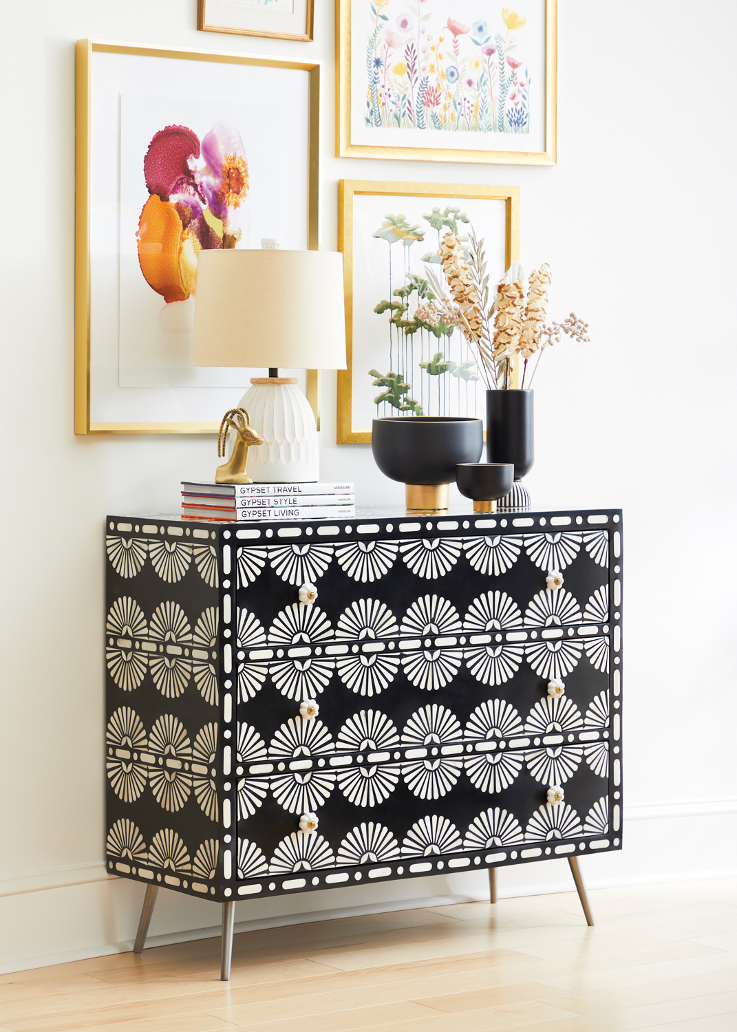 A black and white printed chest with art overhead. RED Winner.