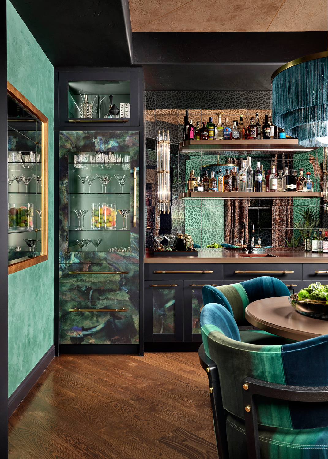 green bar room with textured walls, mirrors and chairs